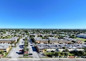 Thumbnail 18 of 18 - A large, open parking lot is surrounded by a variety of buildings.