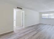 Thumbnail 8 of 18 - A room with a white door and a window with blinds.