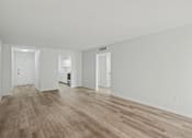 Thumbnail 21 of 41 - A room with wooden floors and white walls.