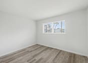 Thumbnail 25 of 41 - Empty room with a window showing a cityscape.