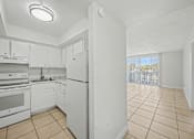 Thumbnail 14 of 41 - A kitchen with white appliances and cabinets.