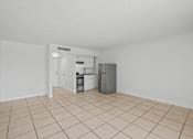 Thumbnail 9 of 41 - A kitchen area with a refrigerator, oven, and sink.