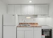 Thumbnail 19 of 26 - A kitchen with white appliances and cabinets.