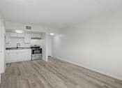 Thumbnail 10 of 26 - A kitchen with white cabinets and a microwave.