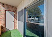 Thumbnail 28 of 29 - A view of a parking lot through a window.