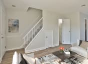 Thumbnail 6 of 17 - a living room with a couch and a coffee table