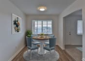 Thumbnail 2 of 17 - a dining room with a table and chairs and a window
