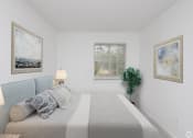 Thumbnail 10 of 17 - a bedroom with a bed and paintings on the wall