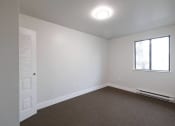 Thumbnail 10 of 13 - an empty room with white walls and a window