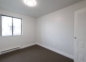 Thumbnail 12 of 13 - an empty room with carpet and a window