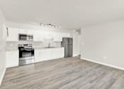 Thumbnail 3 of 19 - a spacious kitchen with white cabinets and stainless steel appliances