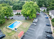 Thumbnail 13 of 16 - an aerial view of a swimming pool in a parking lot