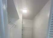 Thumbnail 21 of 21 - A white room with a wooden floor and a staircase.