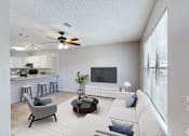 Thumbnail 1 of 17 - A living room with a grey armchair, a white sofa, and a black coffee table.