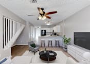 Thumbnail 4 of 17 - A living room with a bar area and a staircase.