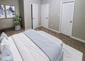 Thumbnail 14 of 17 - A bedroom with a bed, a ceiling fan, and a plant.