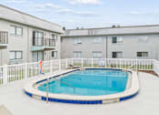 Thumbnail 13 of 14 - A small round pool with a white fence around it.