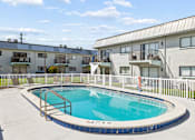 Thumbnail 14 of 14 - A small pool in a courtyard surrounded by apartment buildings.