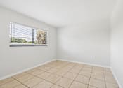 Thumbnail 6 of 14 - A room with a window and tiled floor.