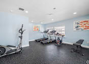 Thumbnail 15 of 23 - A spacious room with exercise equipment and a treadmill.