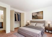 Thumbnail 5 of 18 - A bedroom with a large bed and a painting on the wall.