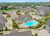 Thumbnail 1 of 20 - an aerial view of a pool and houses in a neighborhood at Encore at Manchester, Novi, 48377