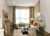 Thumbnail 13 of 20 - a living with a couch and a window at Encore at Manchester, Novi, Michigan