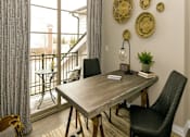 Thumbnail 6 of 20 - a dining room with a table and chairs and a balcony at Encore at Manchester, Michigan