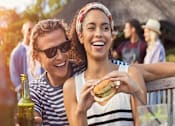 Thumbnail 8 of 20 - a group of young women eating hamburgers at a picnic at Encore at Manchester, Novi, 48377