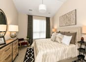 Thumbnail 10 of 20 - a bed and a window at Encore at Manchester, Novi, MI