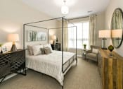 Thumbnail 9 of 20 - a bedroom with a bed and a large window at Encore at Manchester, Novi
