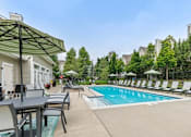 Thumbnail 13 of 35 - Swimming Pool With Relaxing Sundecks at Encore Townhomes, Utica, MI, Michigan
