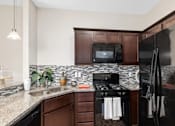 Thumbnail 27 of 35 - Updated Kitchen With Black Appliances at Encore Townhomes, Michigan , 48315