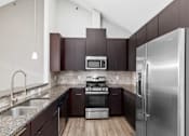 Thumbnail 30 of 35 - Modern kitchen with stainless steel appliances and granite counter tops at Encore Townhomes, Utica, 48315