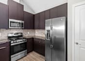 Thumbnail 32 of 35 - Modern Kitchen With Stainless Steel Appliances And Double Door Refrigerators at Encore Townhomes, Utica