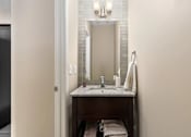 Thumbnail 34 of 35 - Bathroom with a sink and a mirror at Encore Townhomes, Utica, MI, Michigan , 48315