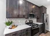 Thumbnail 19 of 38 - Large Island Kitchen With Custom Cabinetry at Encore at West Valley, White Lake, MI, 48386