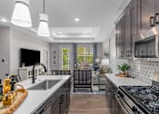 Thumbnail 17 of 38 - Modern Kitchen With Custom Cabinet at Encore at West Valley, Michigan