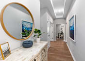 Thumbnail 14 of 38 - Hallway with a round mirror and a painting on the wall at Encore at West Valley, White Lake