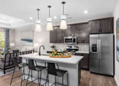 Thumbnail 11 of 38 - Fully Furnished Kitchen With Stainless Steel Appliances at Encore at West Valley, White Lake, MI