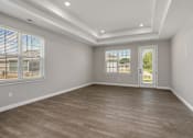 Thumbnail 8 of 38 - Living room with light wood flooring and white walls at Encore at West Valley, Michigan