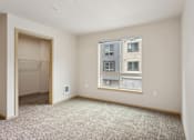 Thumbnail 29 of 32 - an empty room with a large window and a closet