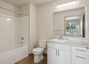 Thumbnail 26 of 32 - a bathroom with a sink toilet and a bath tub