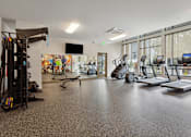 Thumbnail 9 of 32 - the gym with treadmills and weights at the belgard apartments