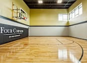 Thumbnail 8 of 32 - a basketball court in a gym with a wood floor