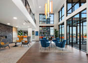 Thumbnail 4 of 25 - A modern interior with a fireplace and blue chairs.