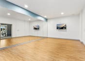 Thumbnail 22 of 46 - A room with wooden floors and two pictures on the wall.