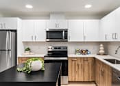Thumbnail 43 of 43 - Kitchen with Black Appliances at Solera Apartments, Renton, 98056