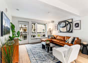 Thumbnail 39 of 43 - Living Room with Brown Leather Couch at Solera Apartments, Washington, 98056