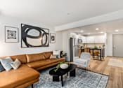 Thumbnail 40 of 43 - Brown Leather Couch in Living Area at Solera Apartments, Renton, WA, 98056